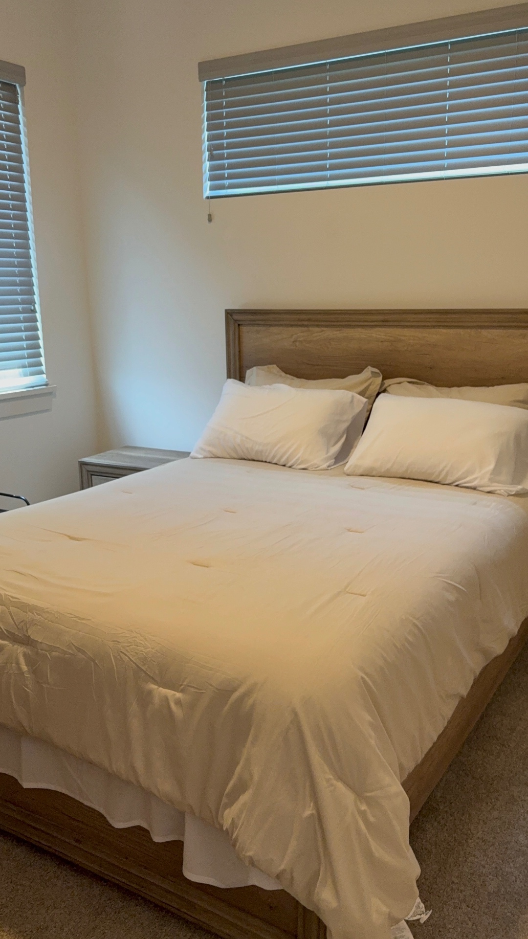Freshly made bed in a cleaned bedroom